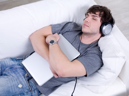 Sleeping man with headphone and laptop